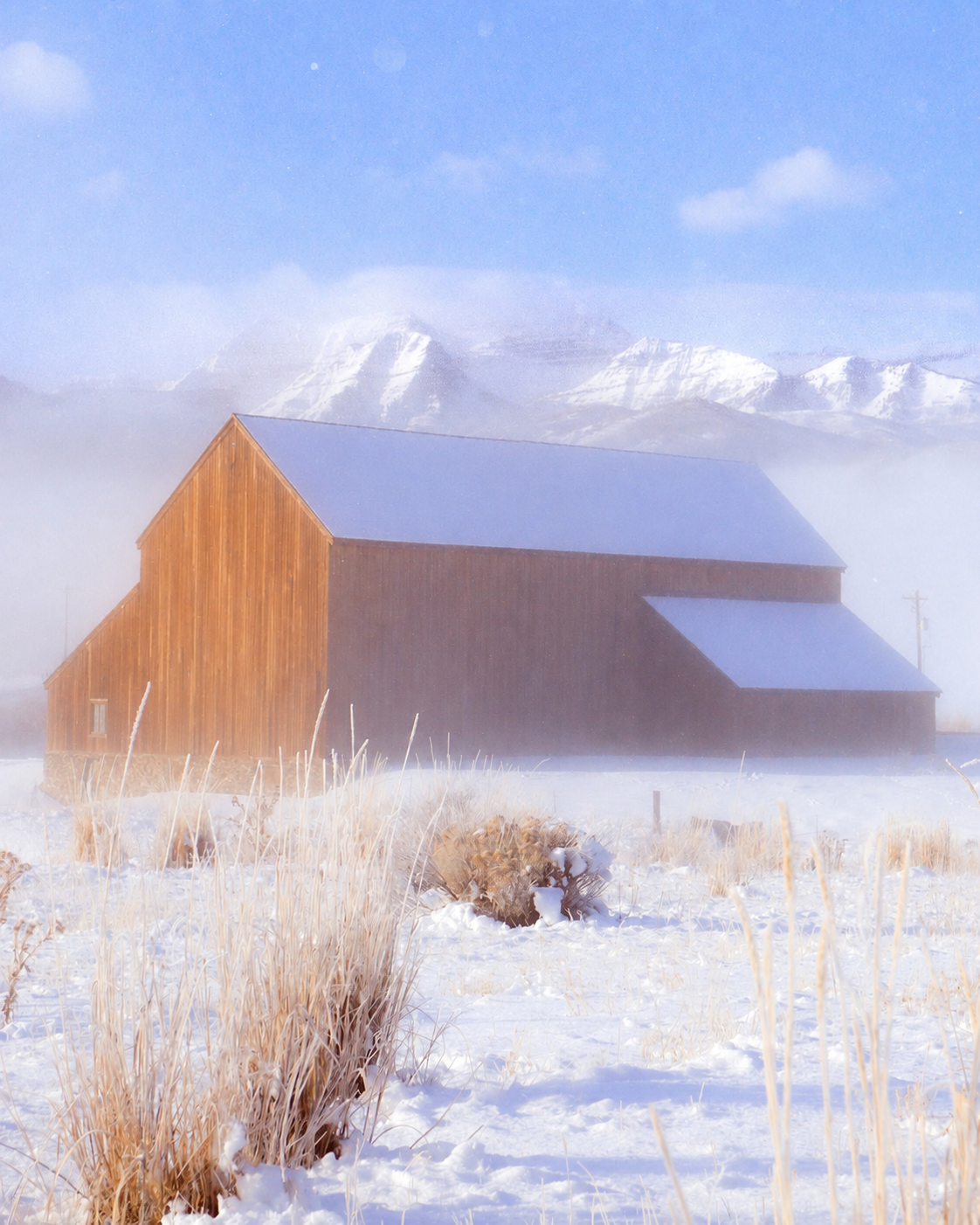 Barn in a snowy winter mountain landscape
